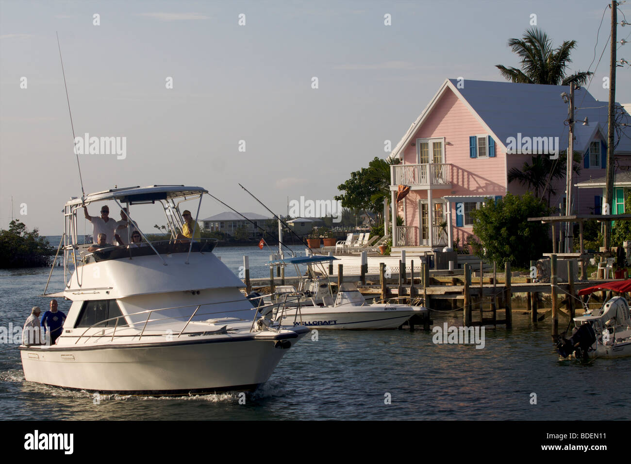 A fishing boat entering Marsh harbour's bay on Great Abaco island Bahamas Stock Photo