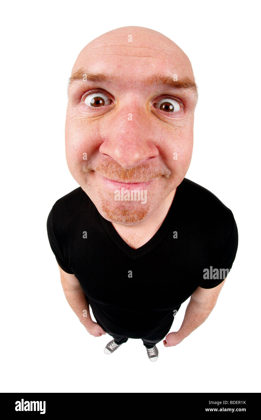 bald headed man grinning featherbrained  into the camera Stock Photo