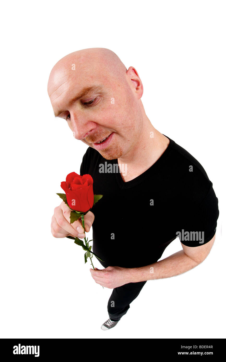 bald headed man with red rose Stock Photo