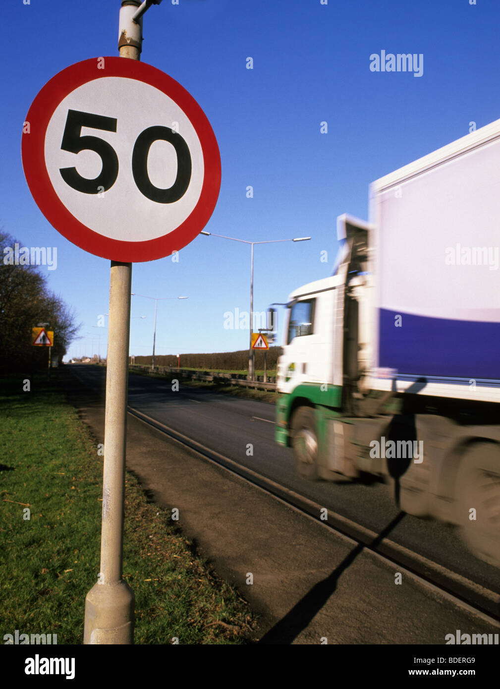 lorry passing 50 miles per hour speed limit warning sign on road in leeds yorkshire uk Stock Photo