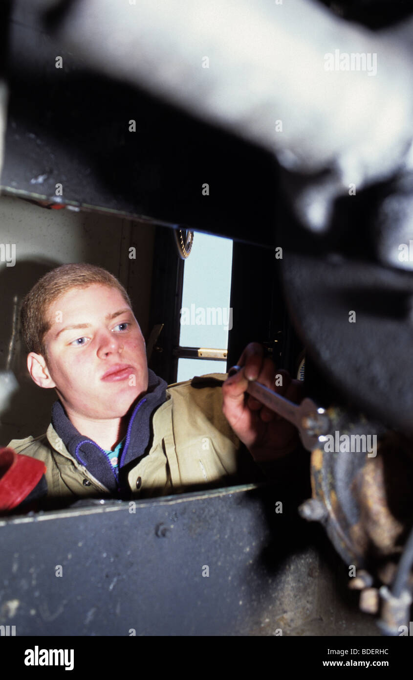 mechanic wiorking on vehicle propshaft Stock Photo