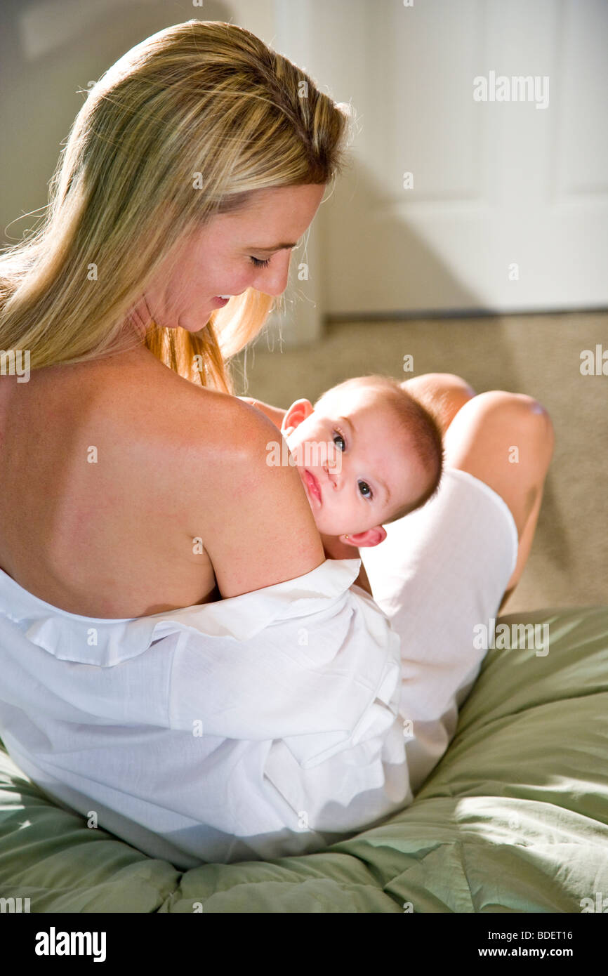 Young mother breastfeeding month old hires stock photography and