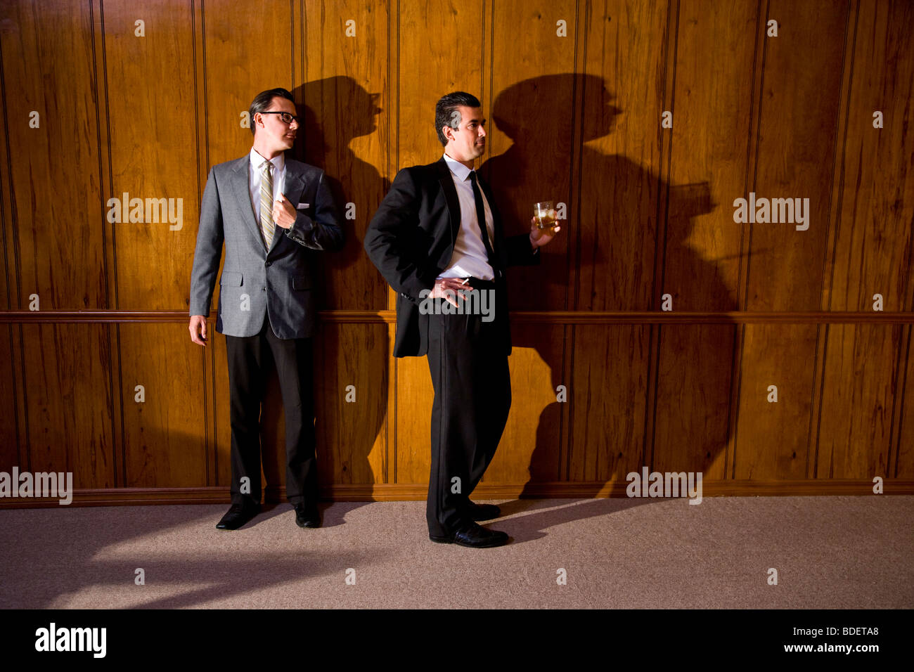 Vintage portrait of two businessmen in boardroom having a drink Stock