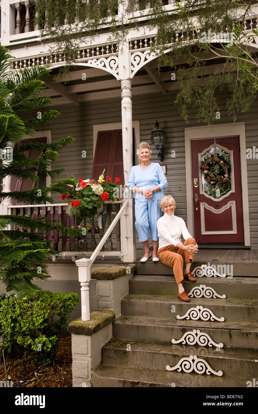 Elderly woman and adult daughter on front porch of house Stock Photo ...
