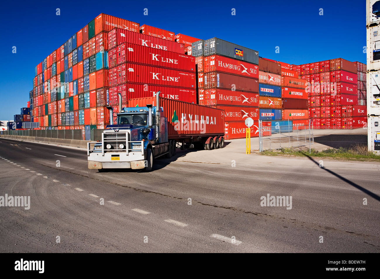 A semitrailer truck hauls a container from a port container depot.The