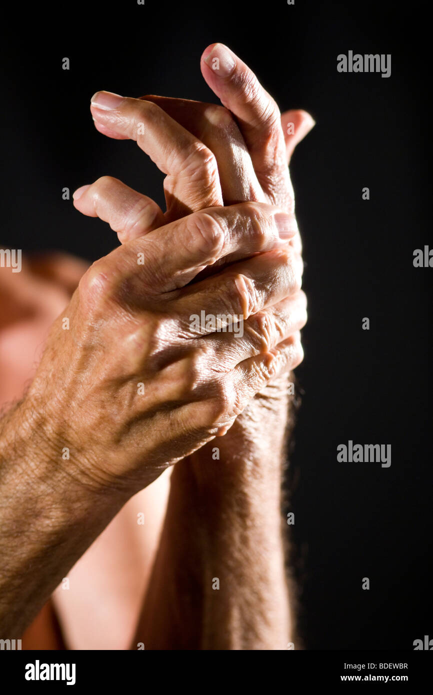 Close-up of senior man rubbing his sore hand Stock Photo
