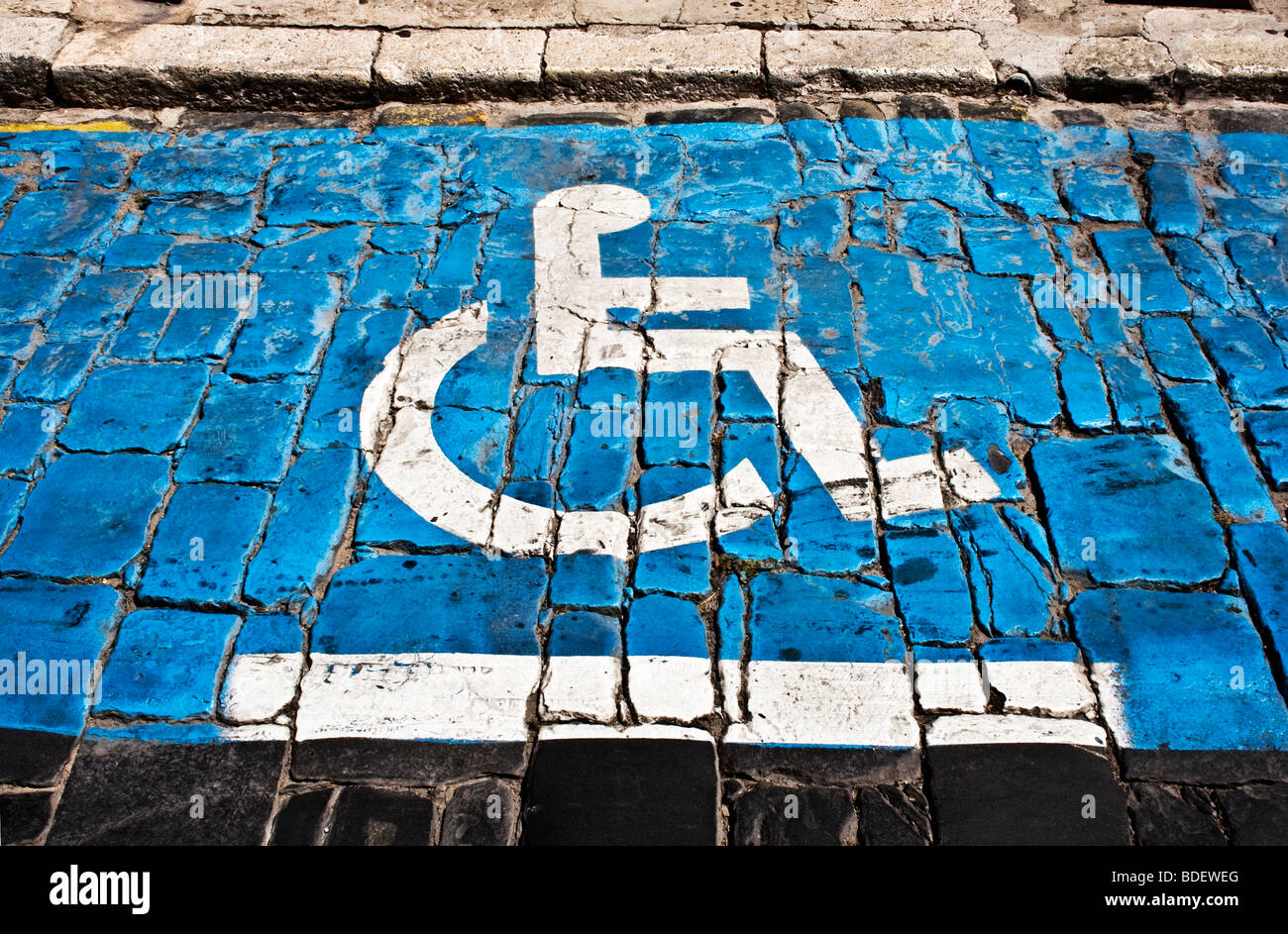 Disabled parking bay on cobbled street. Stock Photo