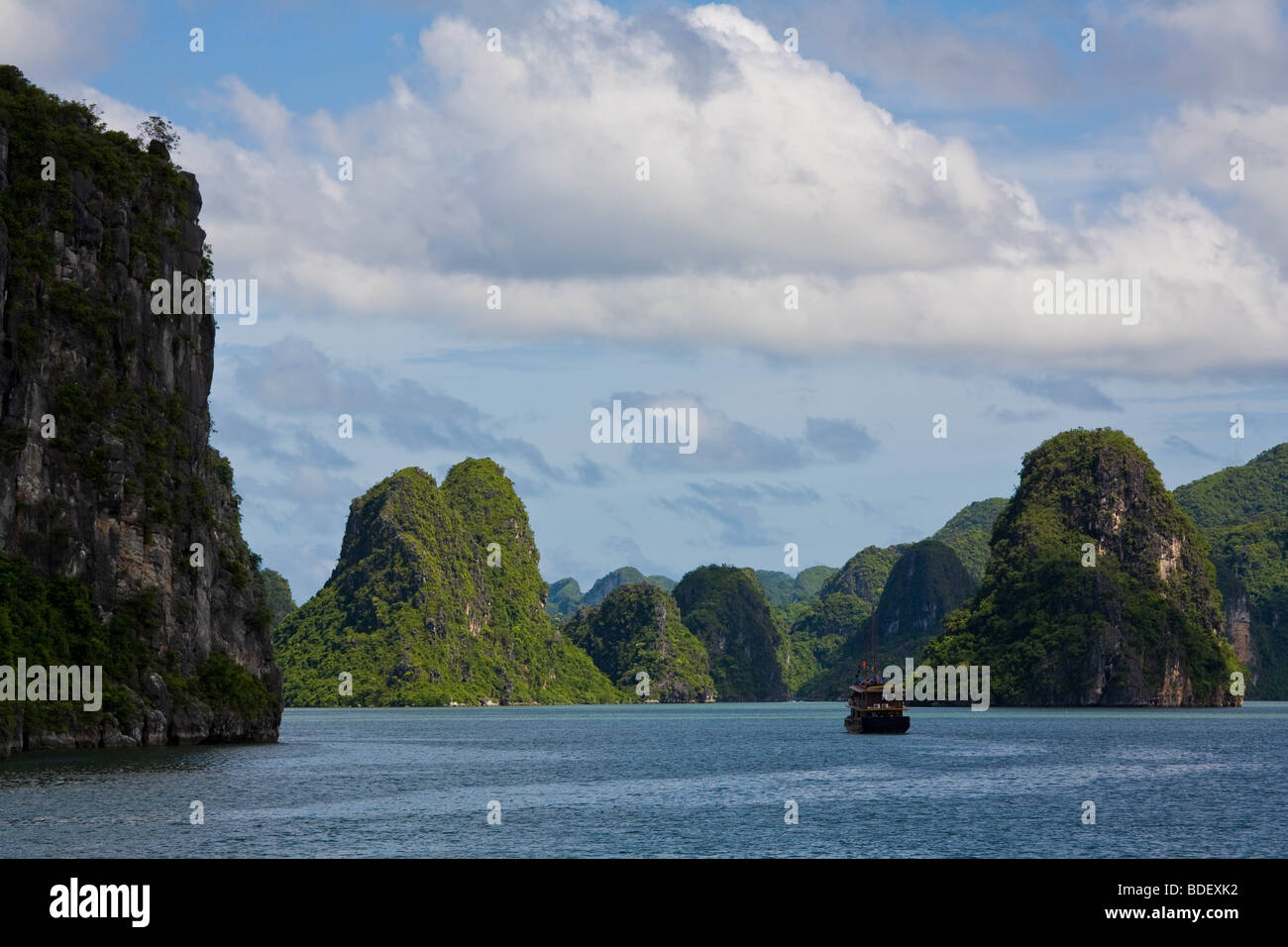 Jungle-covered limestone islands with sheer cliffs in Halong Bay, Vietnam Stock Photo