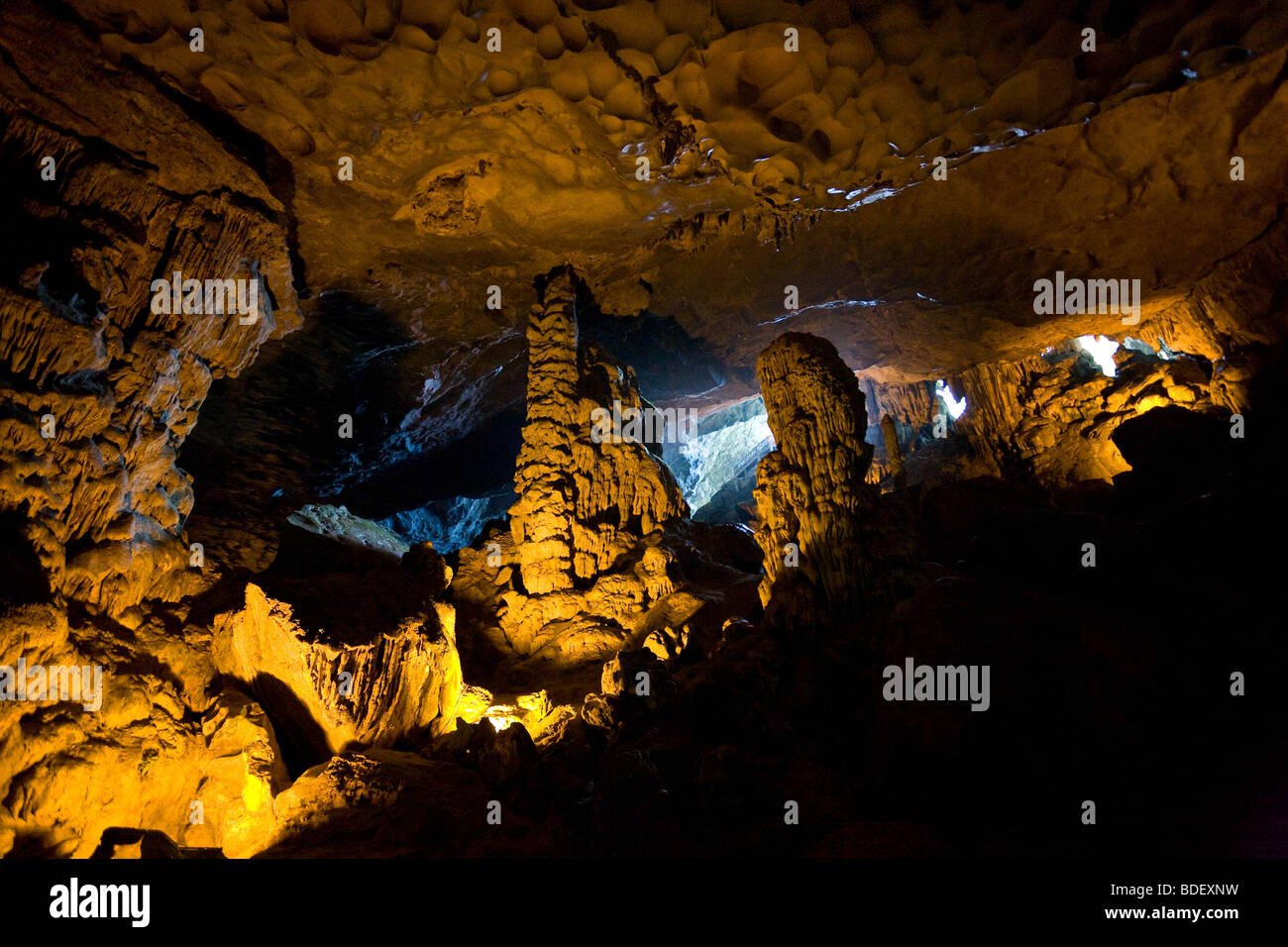 Inside the floodlit cave of Hai Phong, massive stalactites cover the bright cave entrance Stock Photo