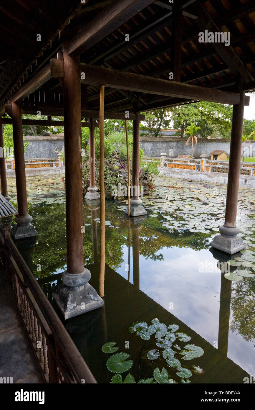 Traditional construction of a small building over a pond on the outskirts of the palace complex of Hue, Vietnam Stock Photo