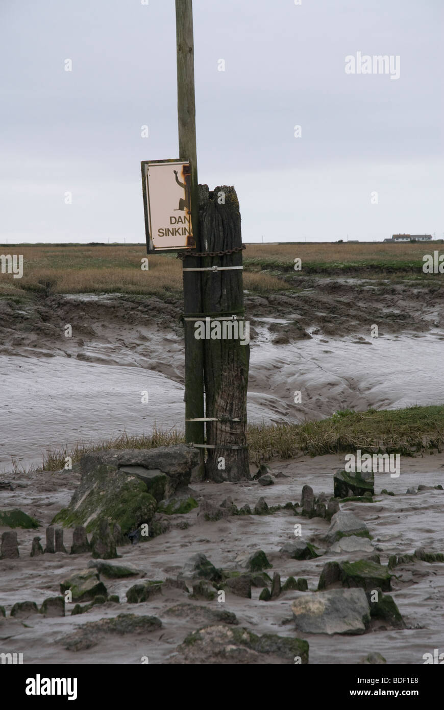 Sign warning of sinking mud on the beach at Weston Super Mare Stock Photo