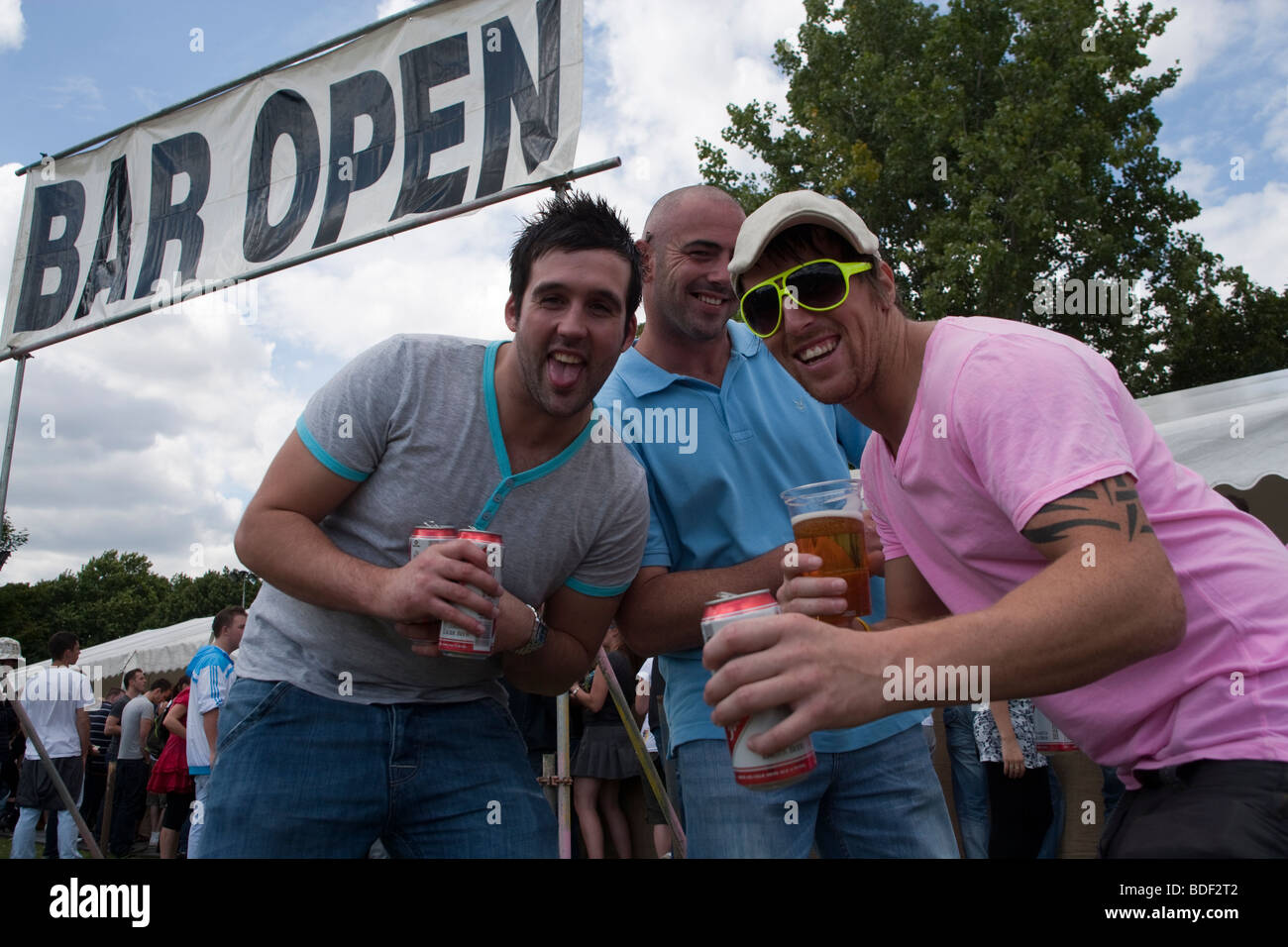 band concert crowd fun fair lake district swings tents young Stock Photo Alamy