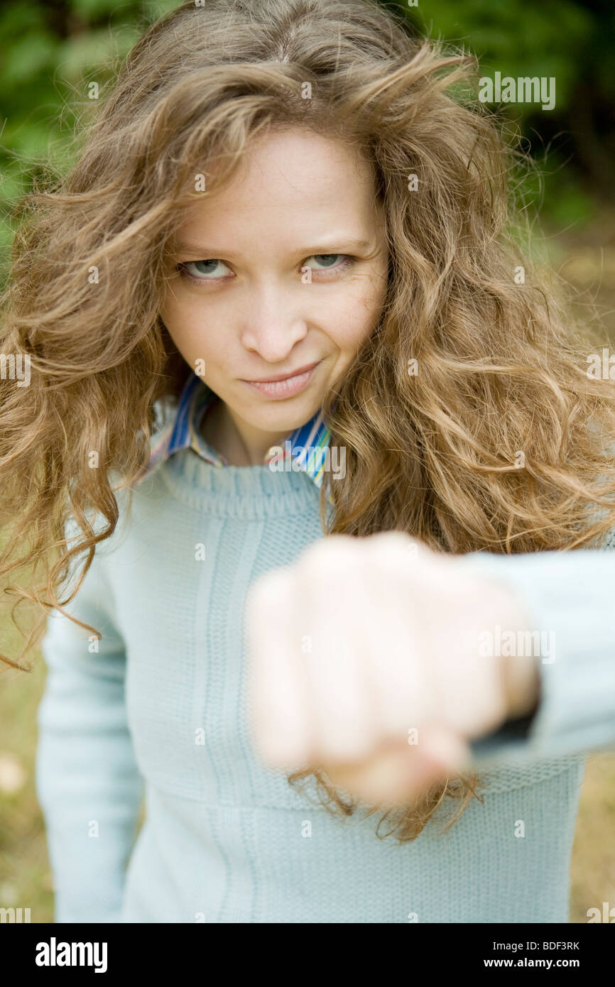 Portrait of an attractive young aggressive female punching Stock Photo