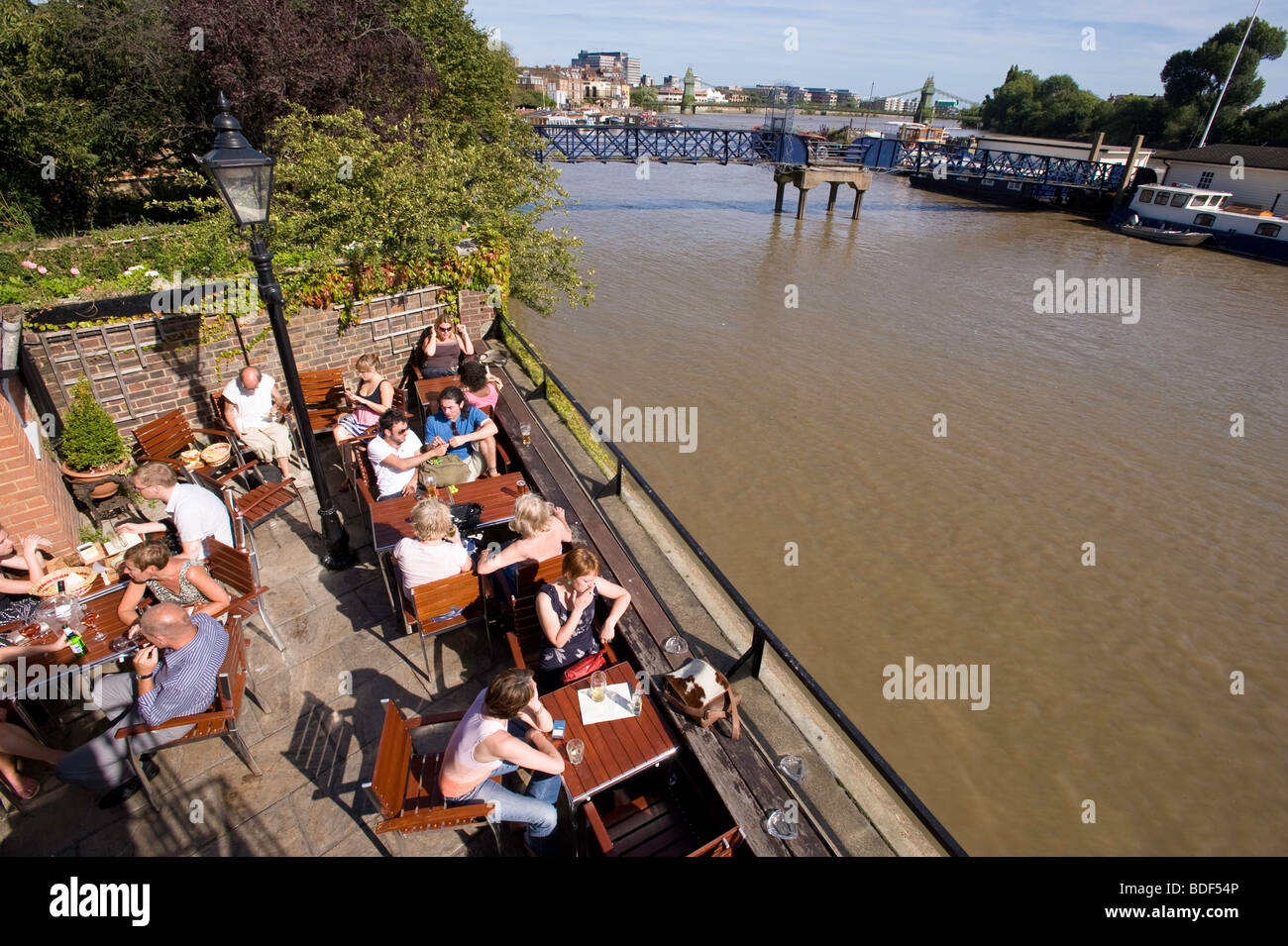 People relax in pub The Dove overlooking Thames river, Hammersmith, W6, London, United Kingdom Stock Photo