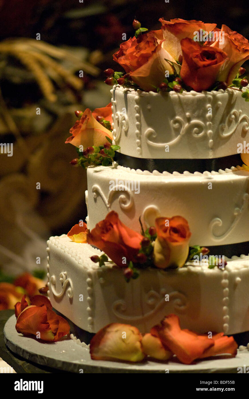 A wedding cake with colorful flowers on it Stock Photo - Alamy
