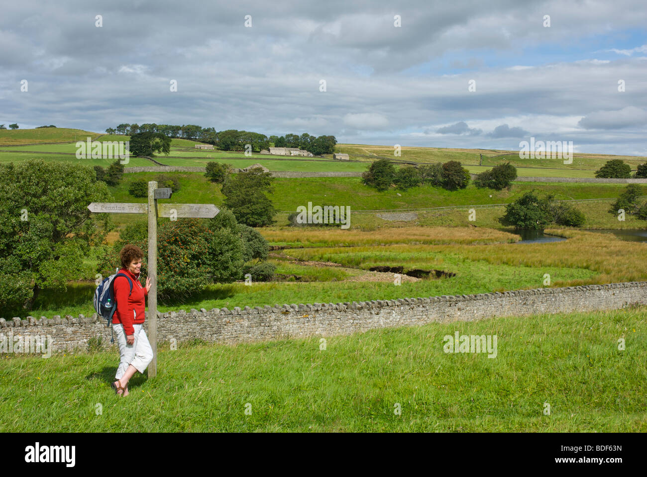 Woman standing next to 'Pennine Way' sign, Baldersdale, County Durham, England UK Stock Photo