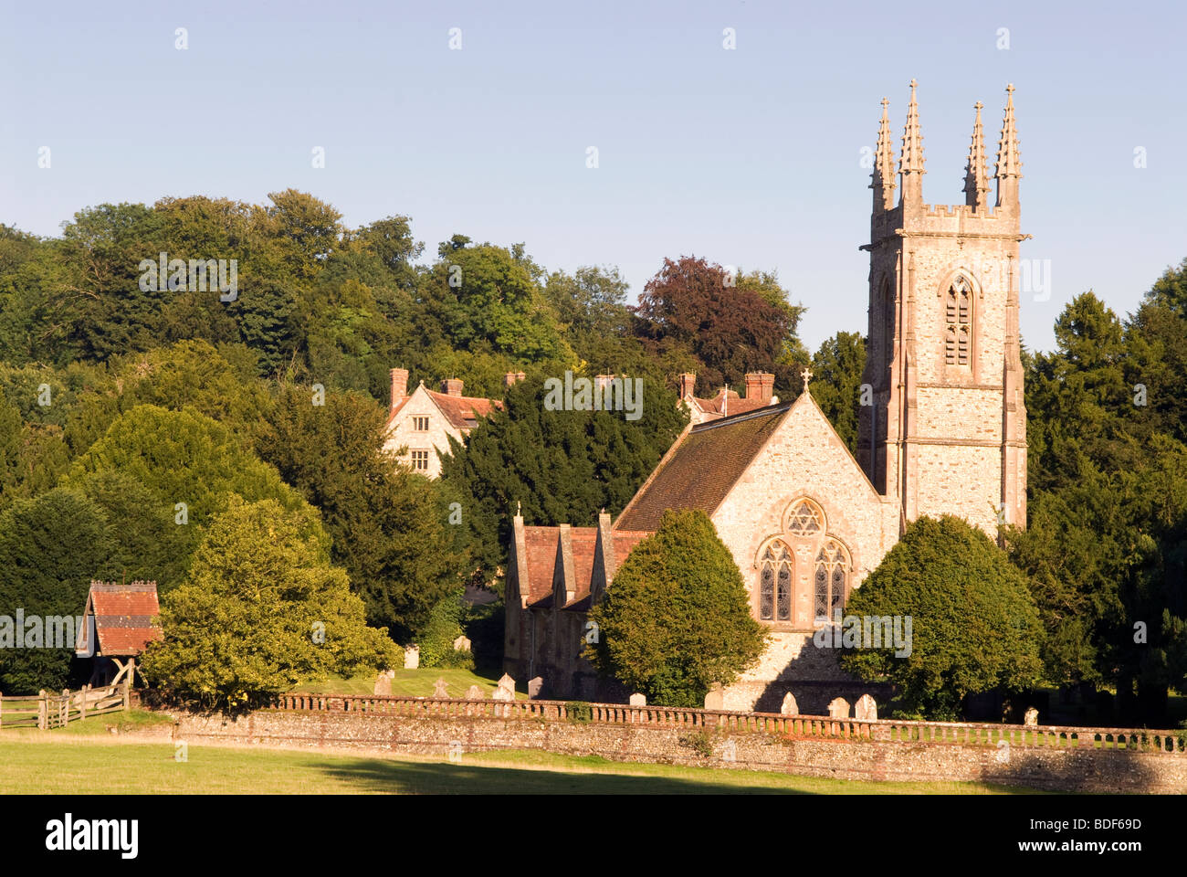 St Nicholas Church nestled between trees in the picturesque village of Chawton, near Alton, Hampshire, UK. Stock Photo