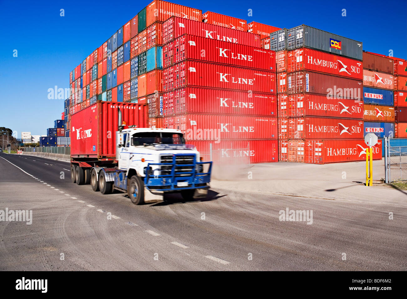 A semi-trailer truck hauls a container from a port container depot.The 'Port of Melbourne' Victoria Australia. Stock Photo