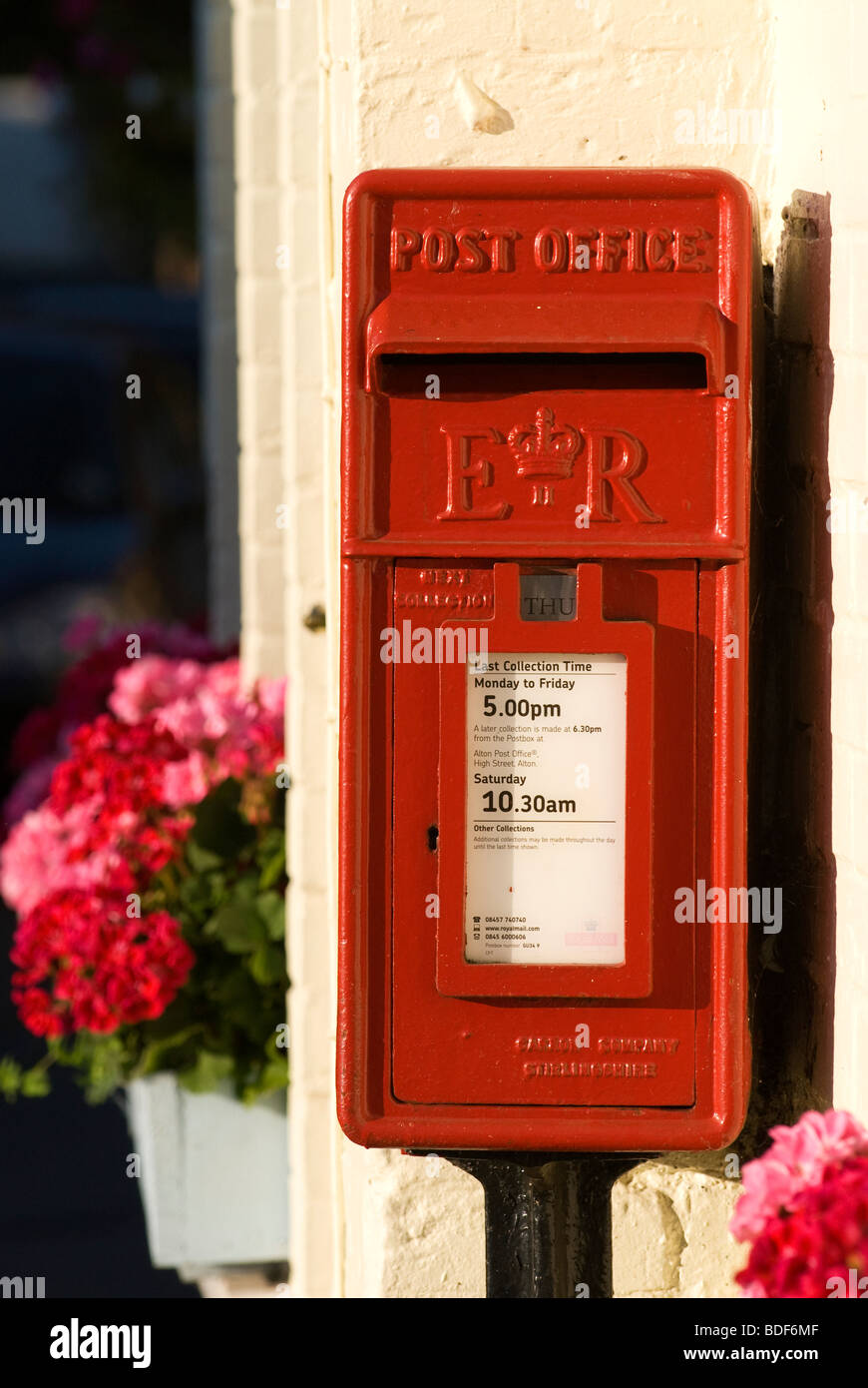 Small Royal Mail posting box in the Hampshire village of Chawton, UK. Stock Photo