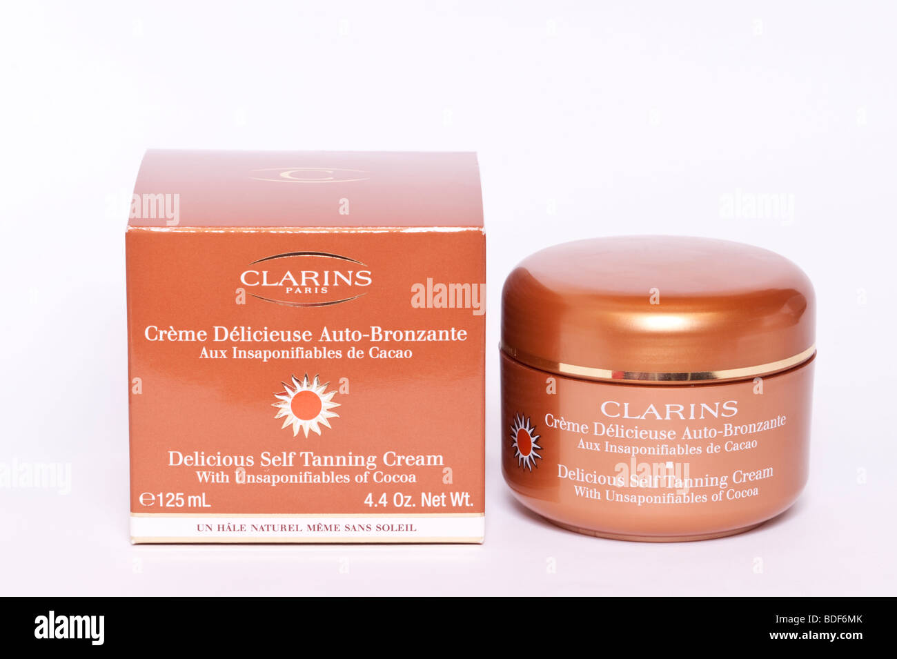 A close up of a bottle of Clarins Delicious self tanning cream on a white  background Stock Photo - Alamy
