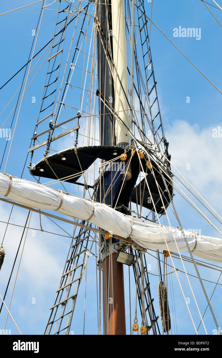 Sailing ship mast detail with sail furled on yardarm, mast top, shrouds