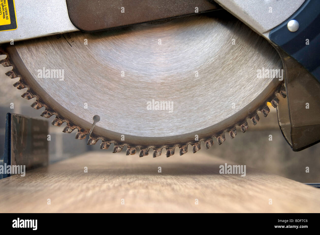 A view of a circular saw blade about to cut a piece of wood Stock Photo