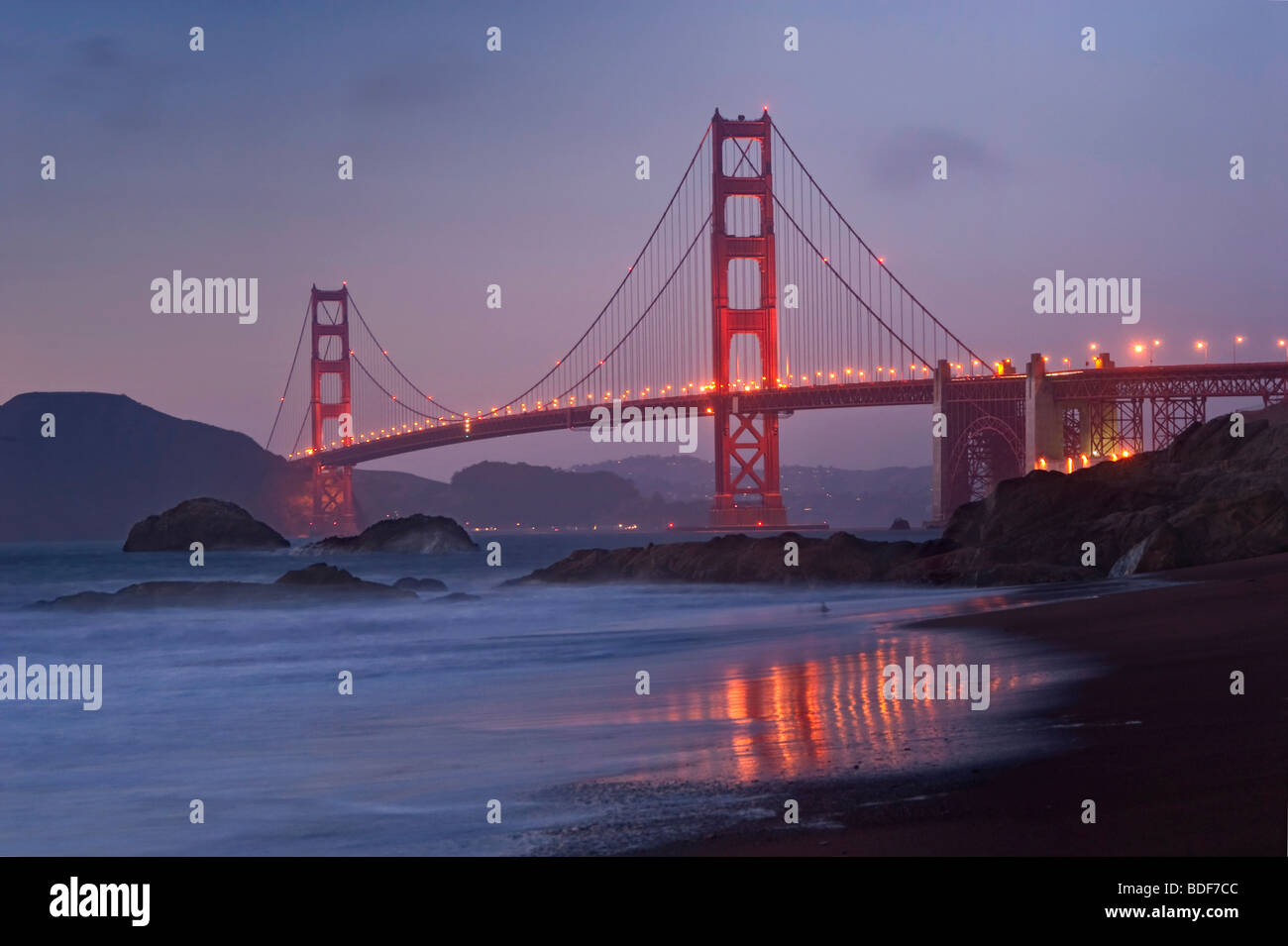 View of world famous Golden Gate Bridge from Baker Beach in San Francisco, California after sunset. Stock Photo