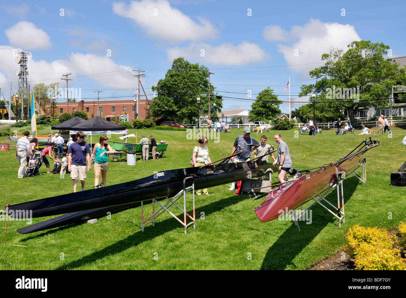 People looking at rowing shells on display at outdoor festival in Hyannis, Cape Cod in summer Stock Photo