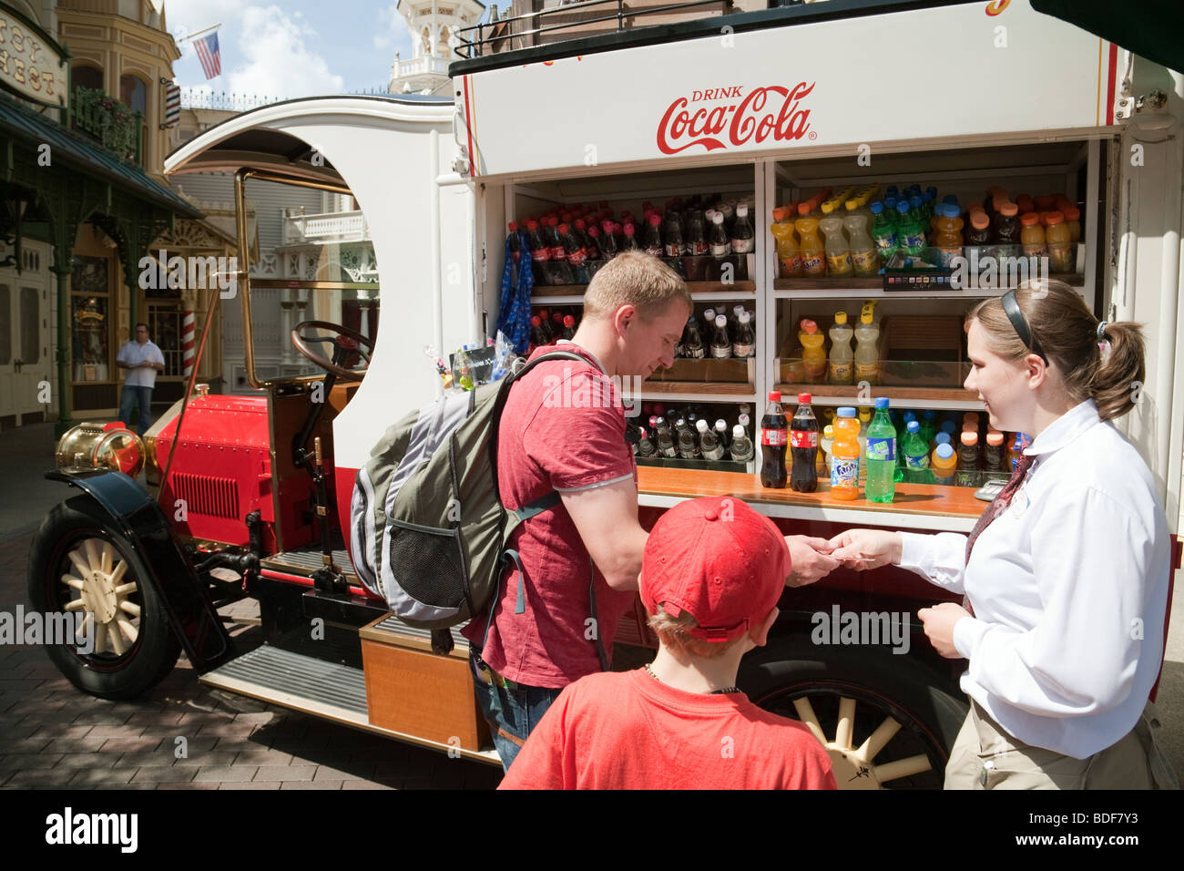 A man buys carbonated drink for his son from a Coca-Cola van, disneyland Paris France Stock Photo