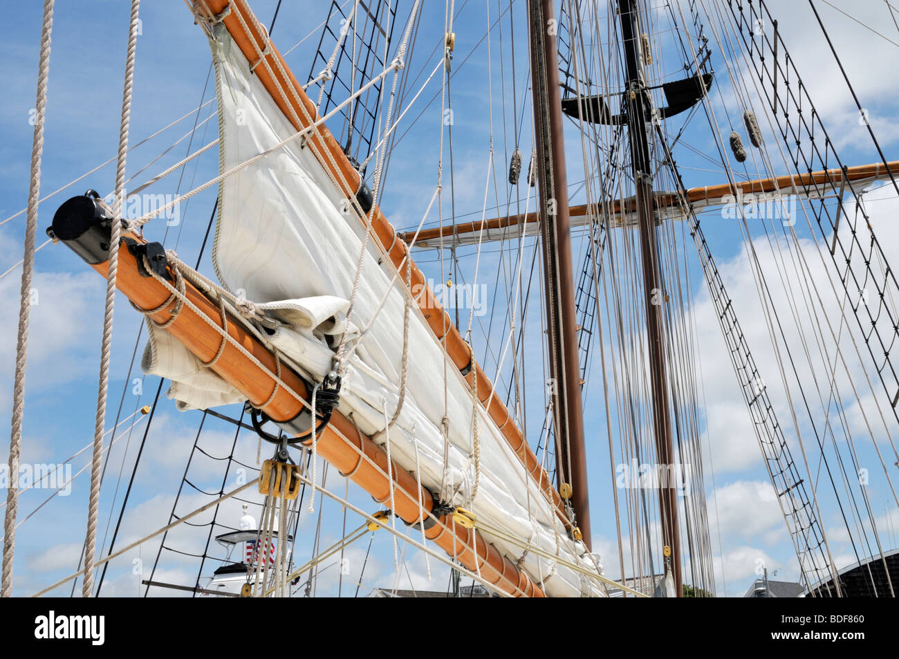 Sailing ship boom and gaff, gaff rigged, with furled sail and masts Stock Photo