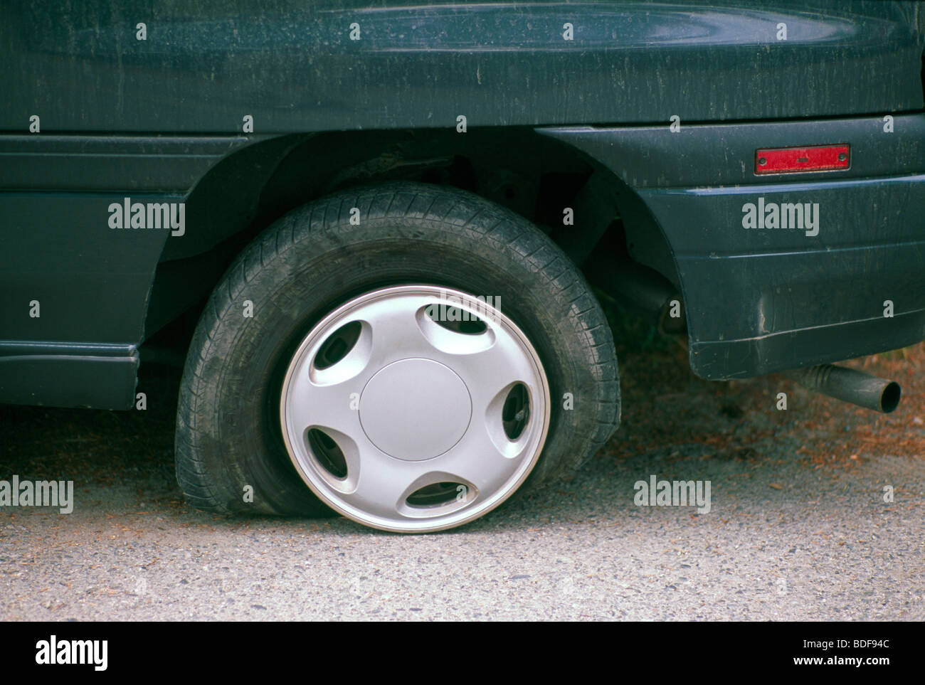 Deflated Flat Tyre / Tire on Car due to Puncture on Road Stock Photo Alamy