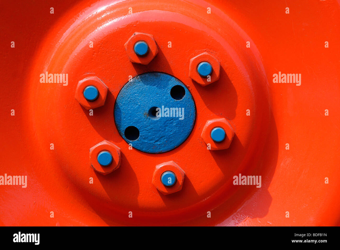 Orange wheel on blue hub Stock Photo