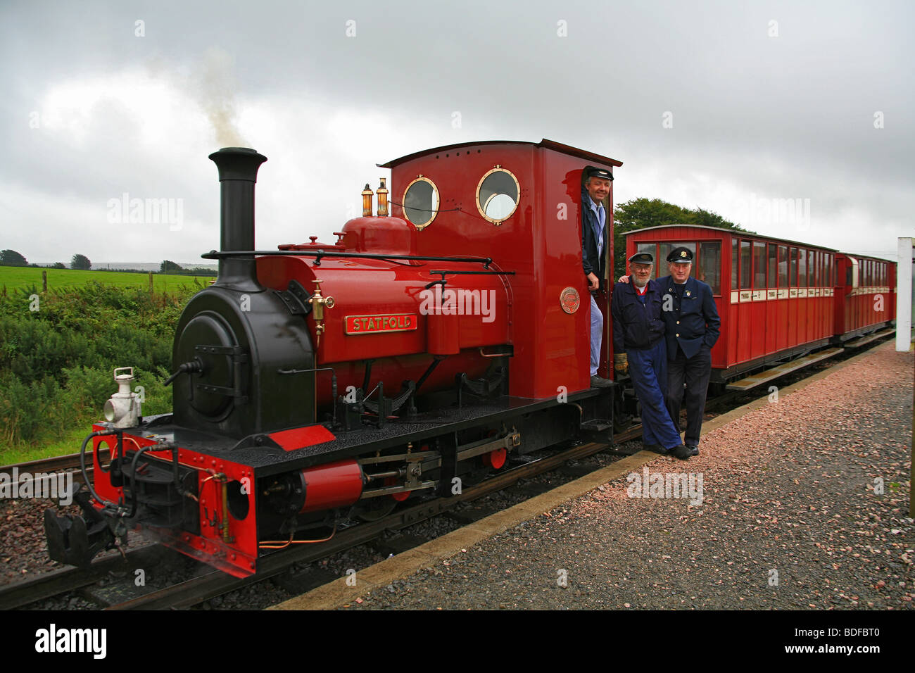 The train crew pose at Killington Lane station on the Lynton & Barnstaple Railway, Devon, England, UK Stock Photo