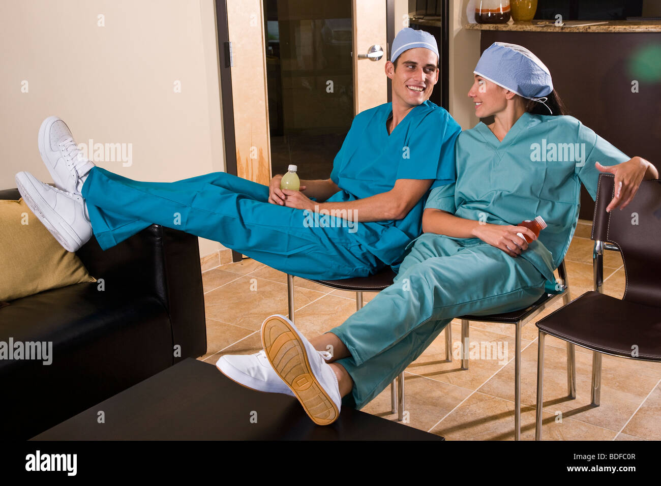 Healthcare workers relaxing in lounge area Stock Photo