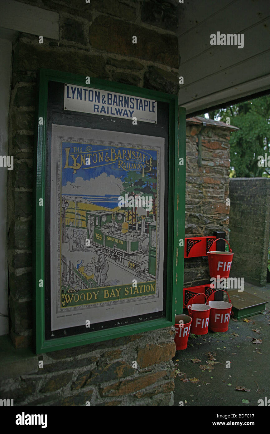 Old poster and fire buckets at Woody Bay station on the Lynton & Barnstaple Railway, Devon, England, UK Stock Photo