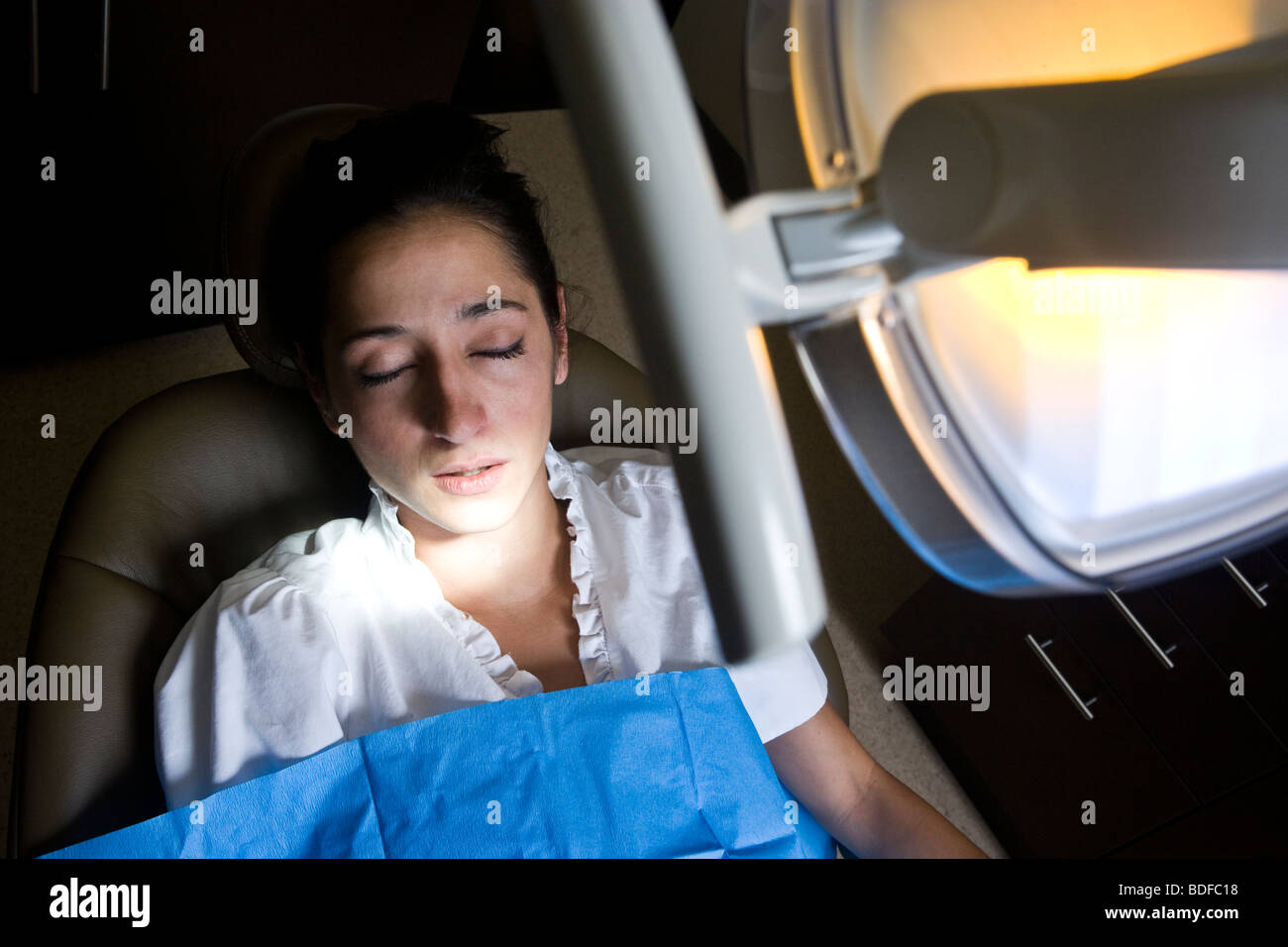 Dental patient in reclining chair with eyes closed Stock Photo