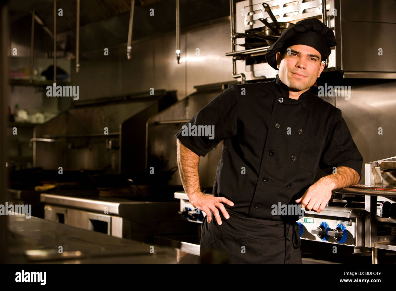Professional chef standing in restaurant kitchen Stock Photo - Alamy