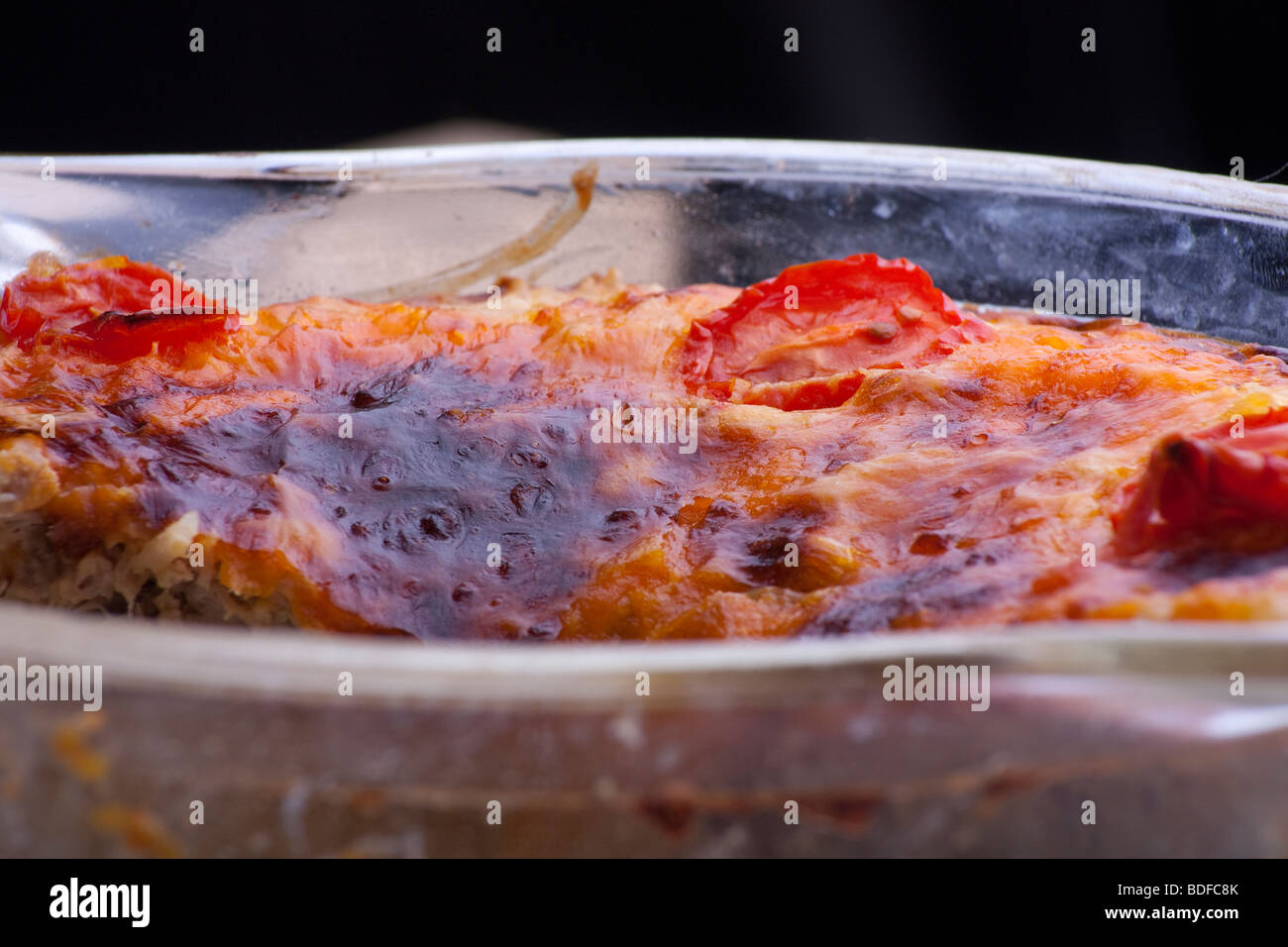 Close up of the cheese and tomato topping on a Home cooked Tuna pie Stock Photo