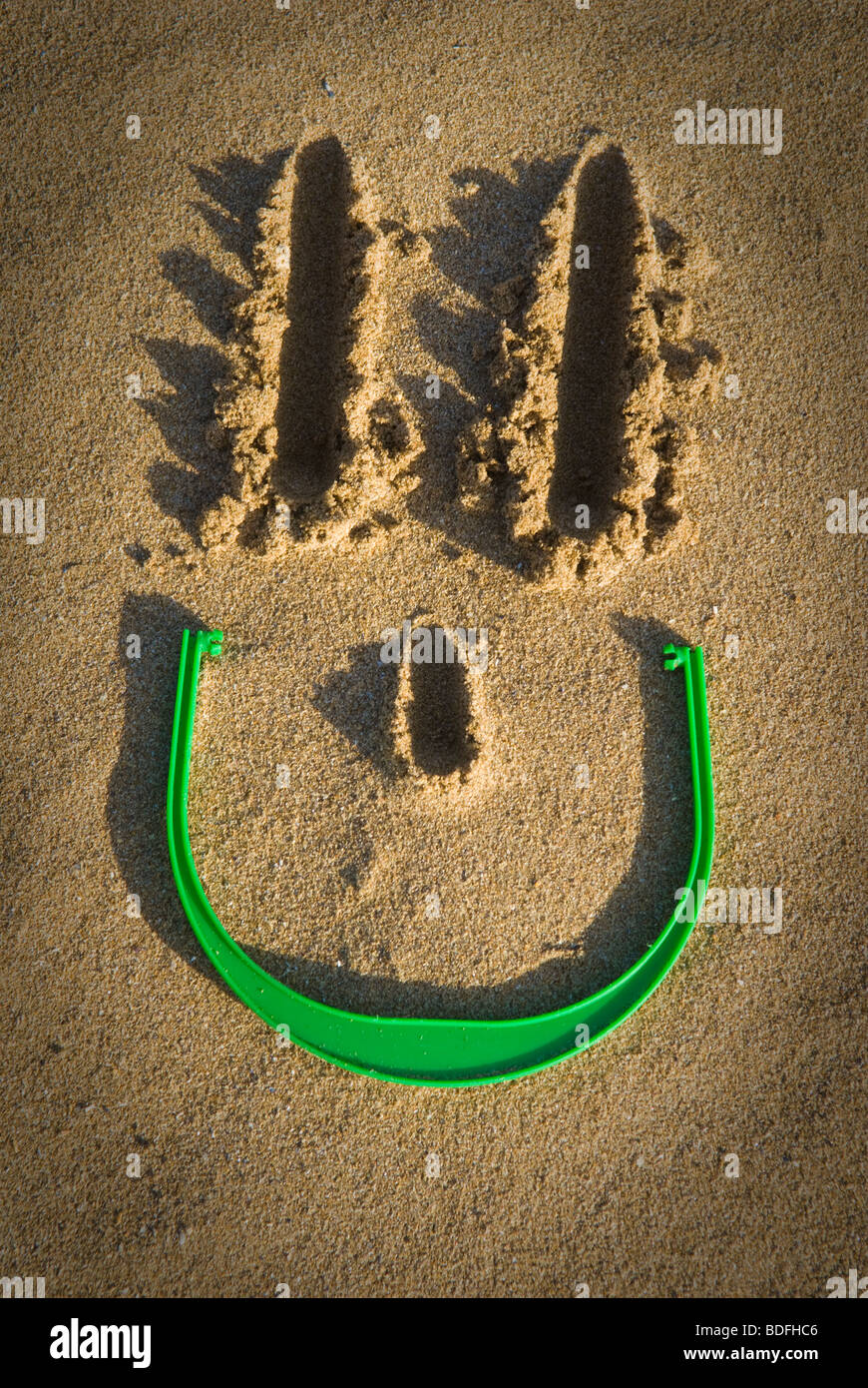 smiley face in the sand Stock Photo