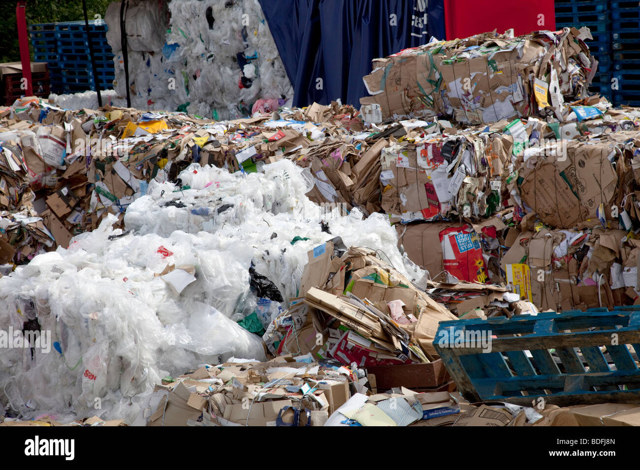 Bales of plastic and cardboard waste for recycling outside Morrisons