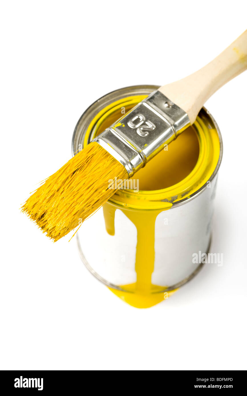 paintbrush with yellow varnish on top of can, white background Stock Photo