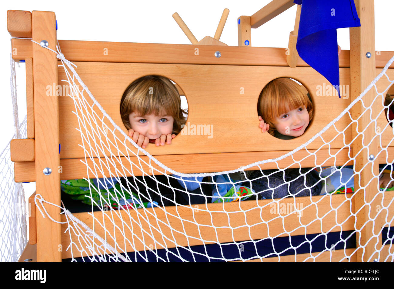 children playing in a Billi-Bolli loft bed, looking through holes Stock Photo