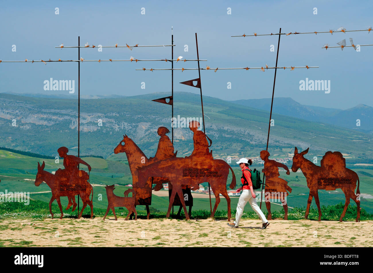 Spain, St. James Way: Pilgrim on fourth stage of the Camino Frances at the Pilgrim´s Monument at Alto del Perdon in Navarra Stock Photo