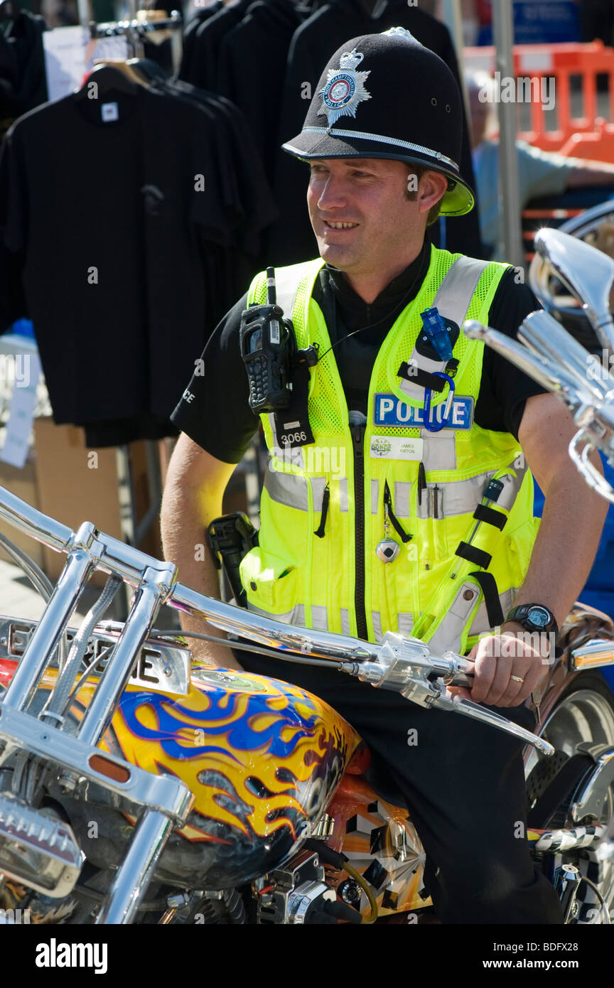 British policeman sitting on a custom Harley Davidson motorcycle at a bike festival Stock Photo