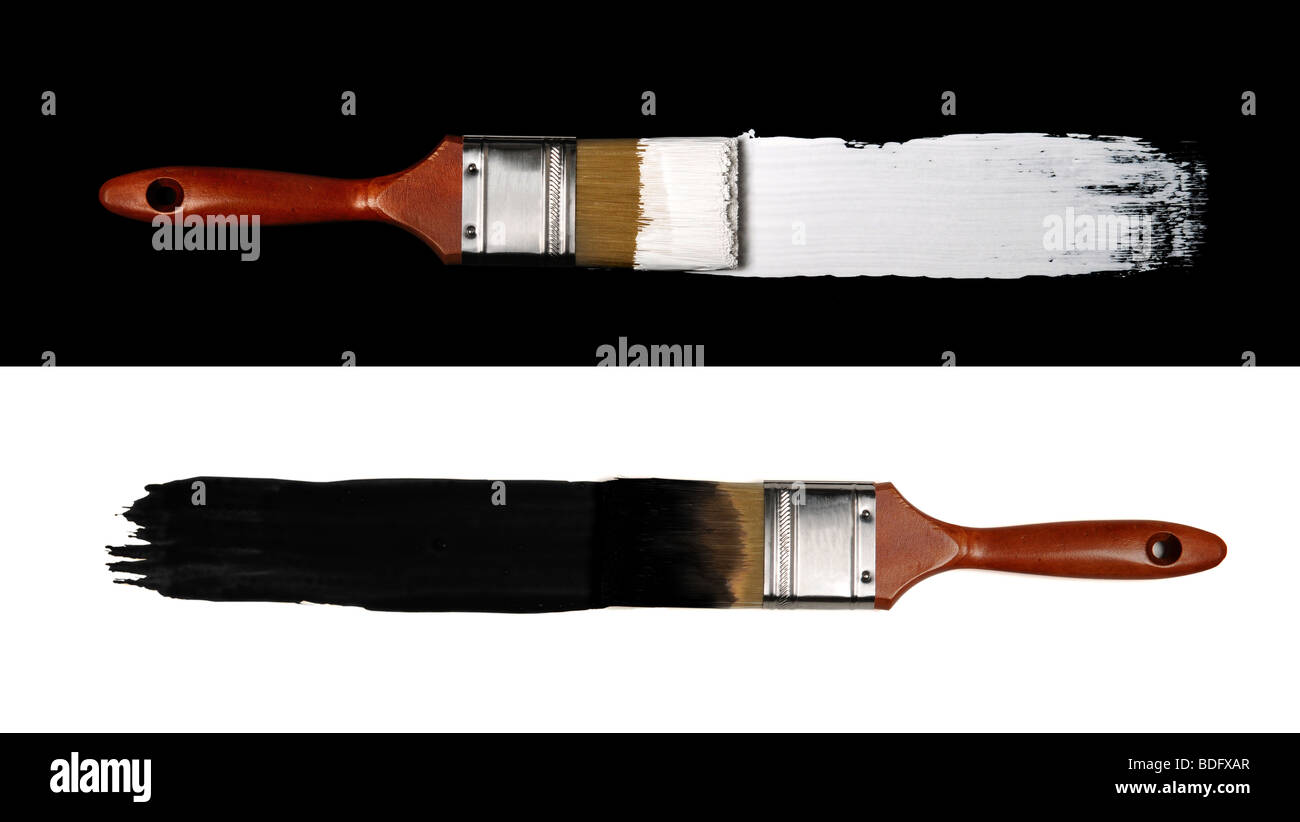 Two paint brushes representing contrast: white paint on black background and black paint on white background Stock Photo