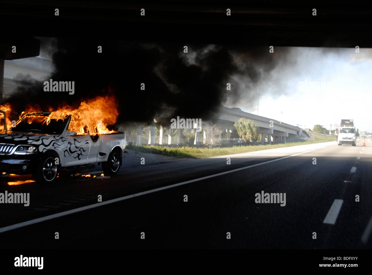 Burning pickup truck in underpass. Stock Photo