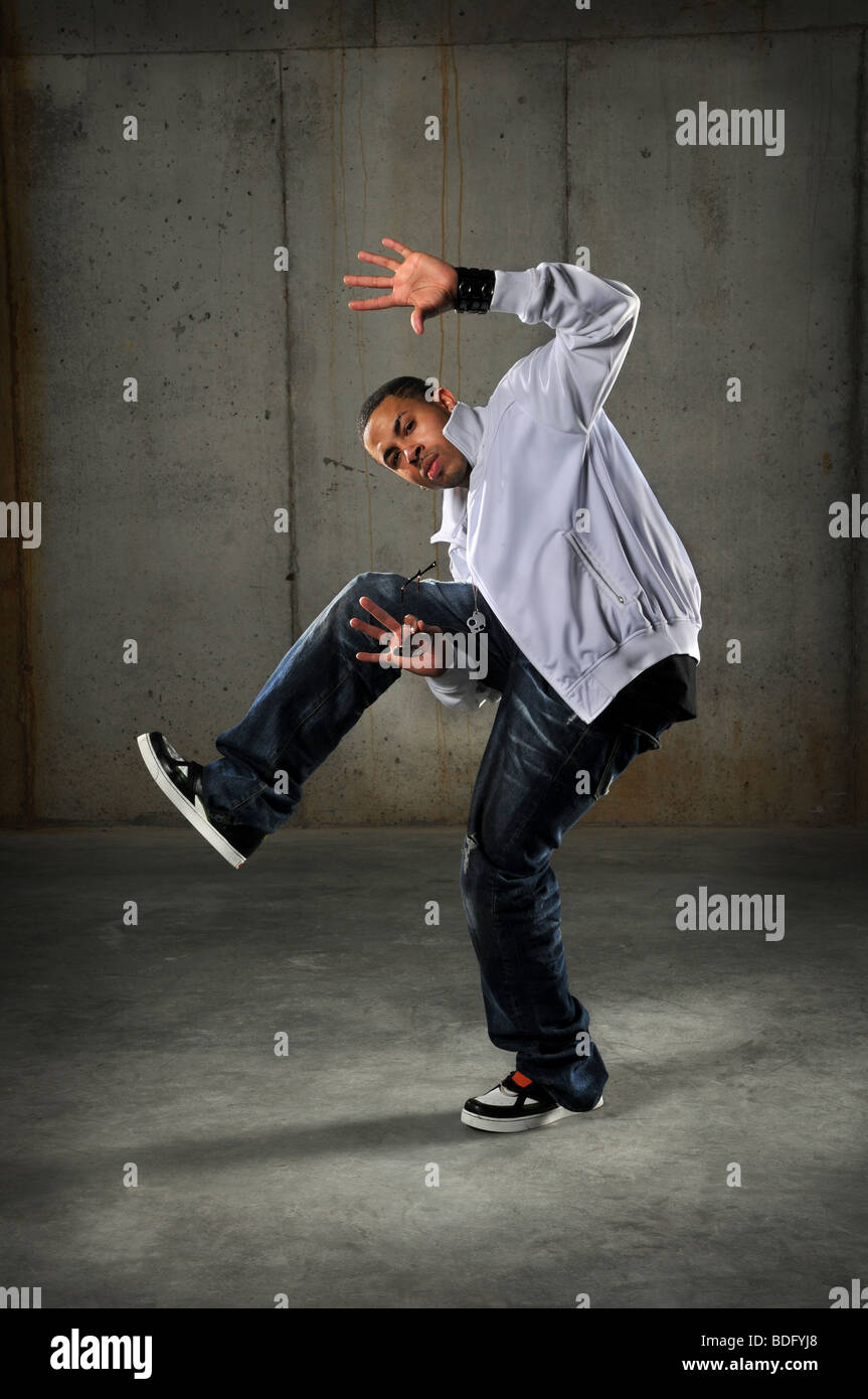African American hip hop dancer performing over grunge background Stock Photo