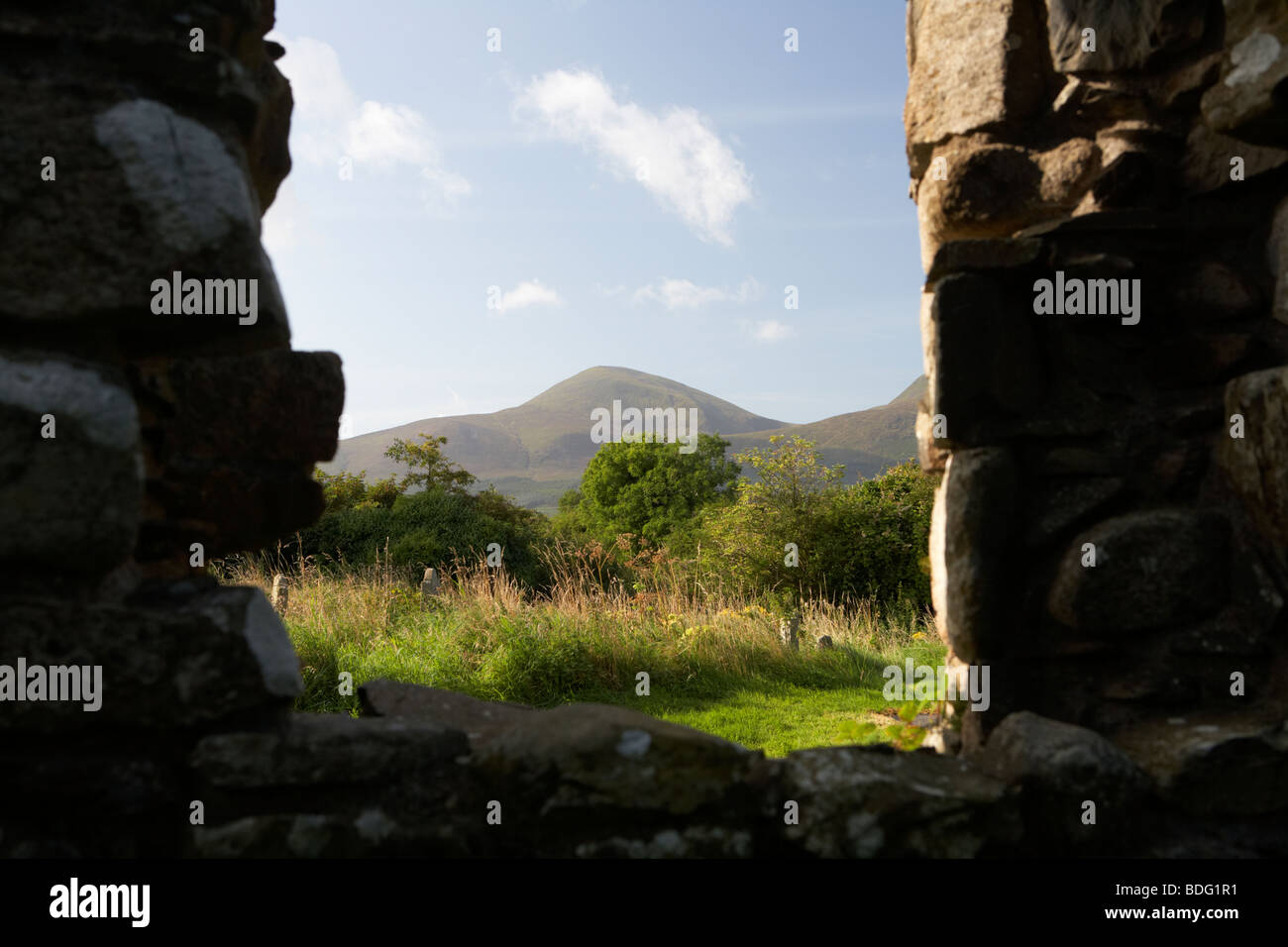 looking out at Slieve Donard in the mourne mountains from the ruins of maghera old church founded by St Donard Stock Photo