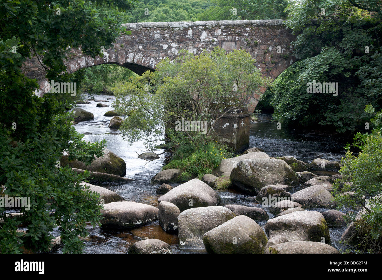 Old stone bridge over the River Dart at Dartmeet, Dartmoor, Devon, UK Stock Photo