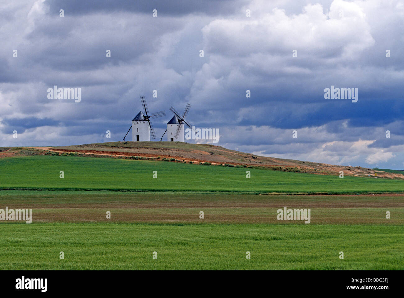 Farm fields and windmills aproaching storm Trembleque Castilla-LaMancha Spain Stock Photo